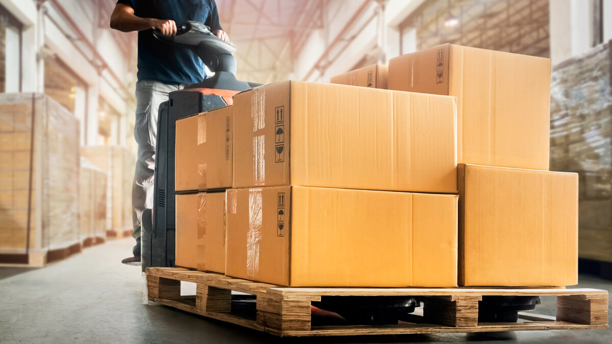 Warehouse worker moving pallets